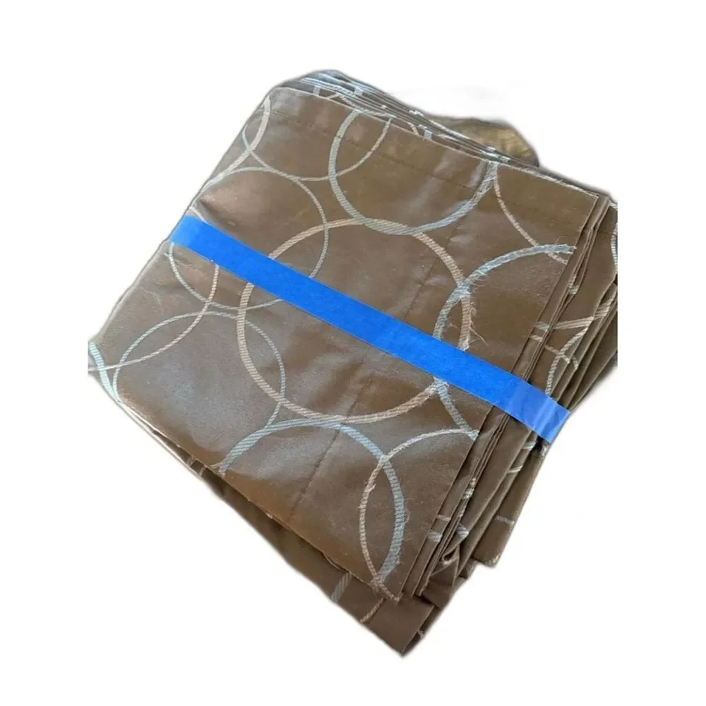 Brown curtain panels with light silver-gray circular embroidered pattern
